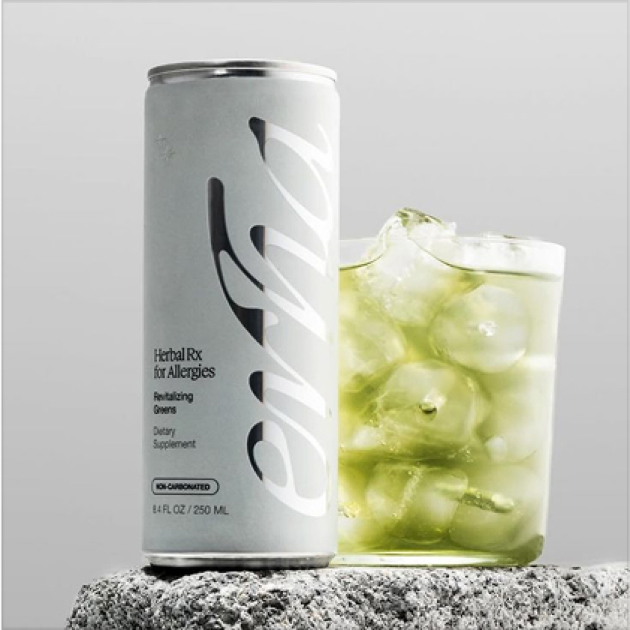 Lata de bebida verde con hielo en un vaso al lado.